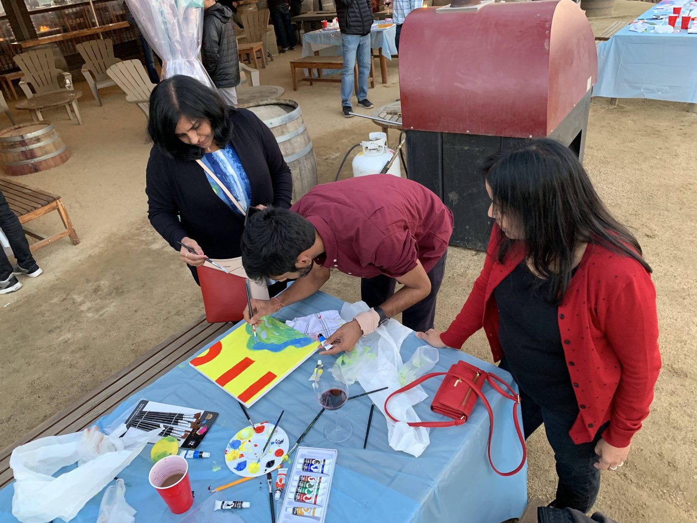 Artists bringing colorful panels together at a team table