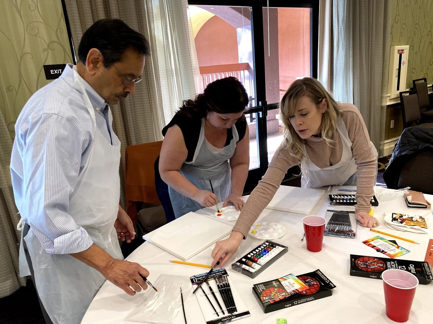 Colleagues discussing their artwork and sharing materials
