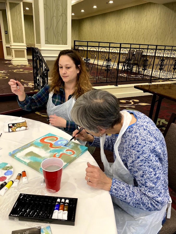 A group drawing and painting together at a round table