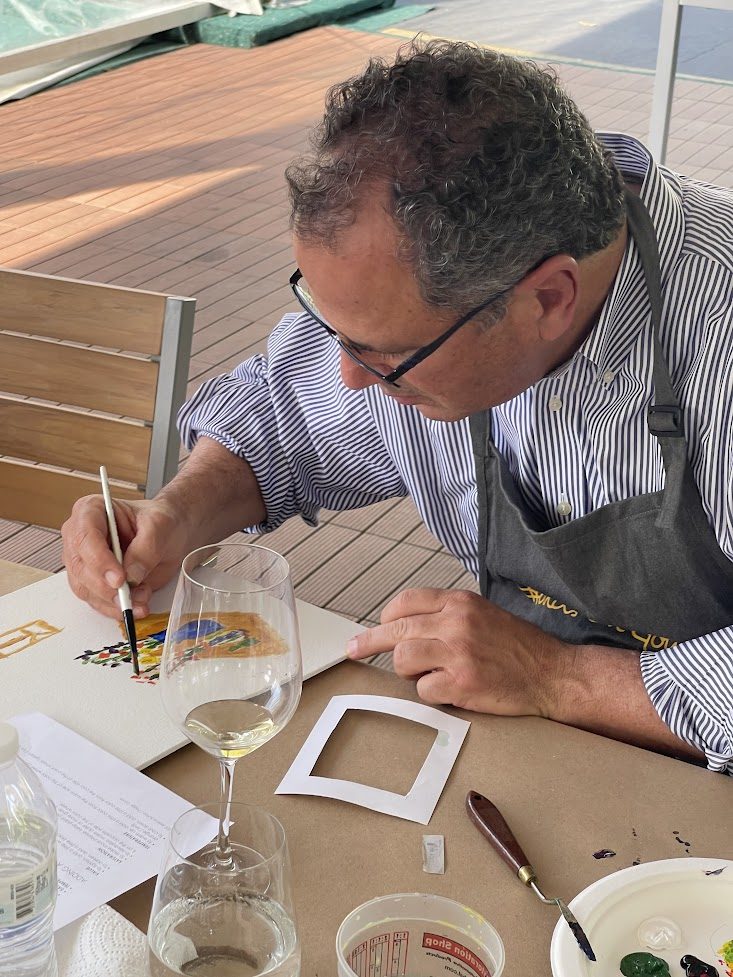 An artist concentrating on a detailed stencil