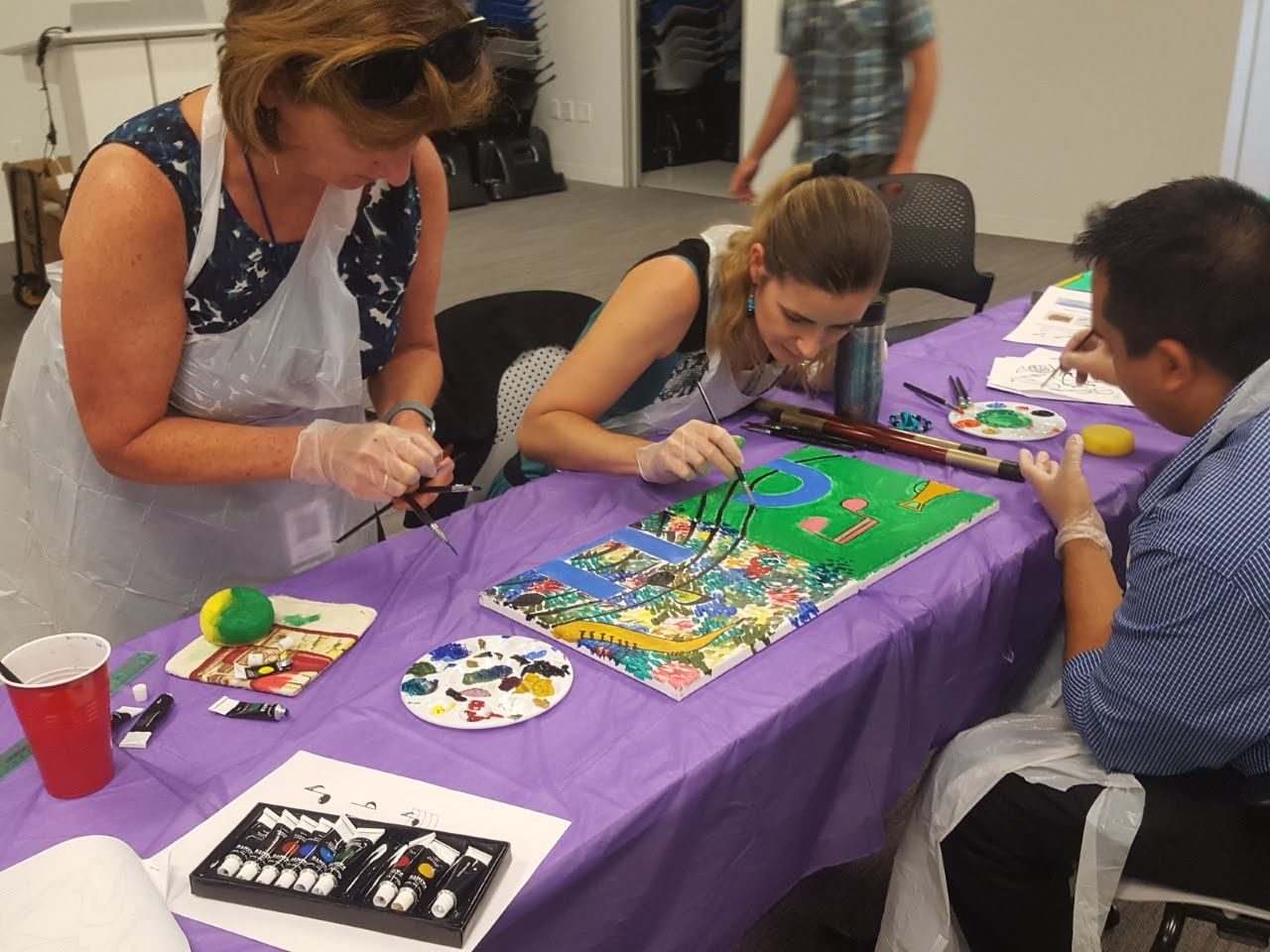 Artists painting vivid patterns together